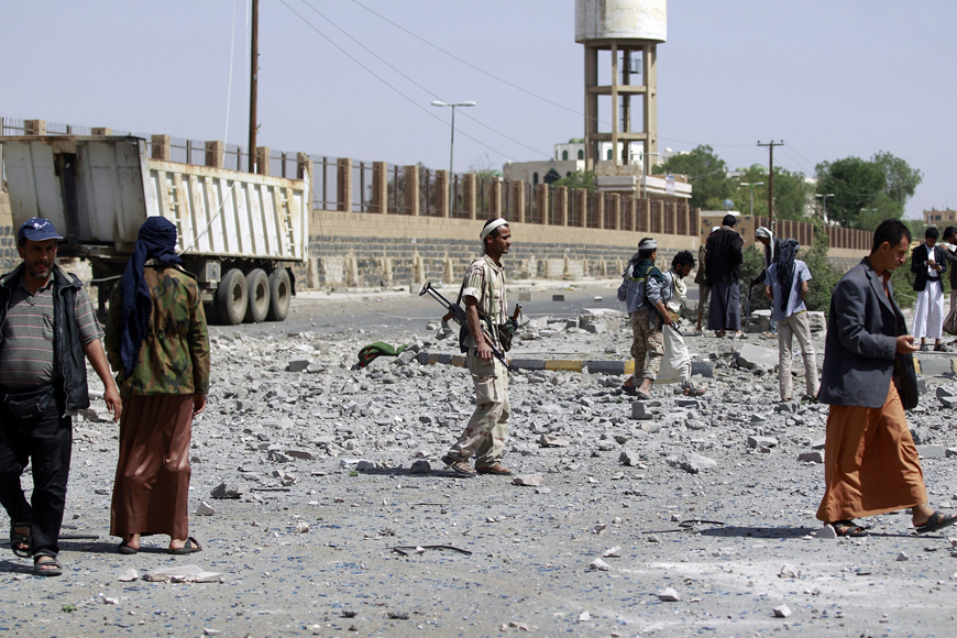 Houthi Shiite militants inspect damage following an air strike by the Saudi-led coalition  on Sunday (AFP photo)